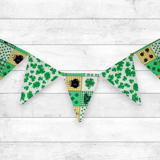 a fabric bunting banner made with alternating saint patrick's day print fabrics