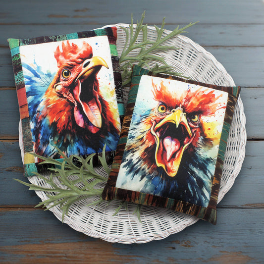 Two colorful rooster towels on a white wicker basket with a wooden background