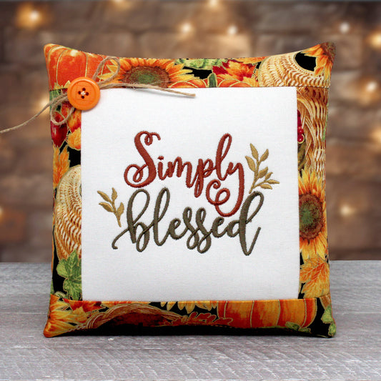 Small pillow tuck or bowl filler for autumn decorating.  The center panel is embroidered with "simply blessed" and it's trimmed with colorful fall fabric.
