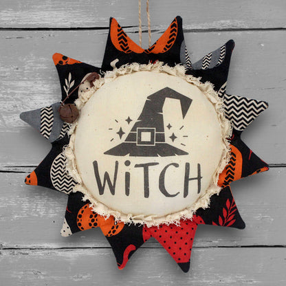 Primitive handmade fabric sunflower ornament for Halloween with a printed center with an image of a witch hat 